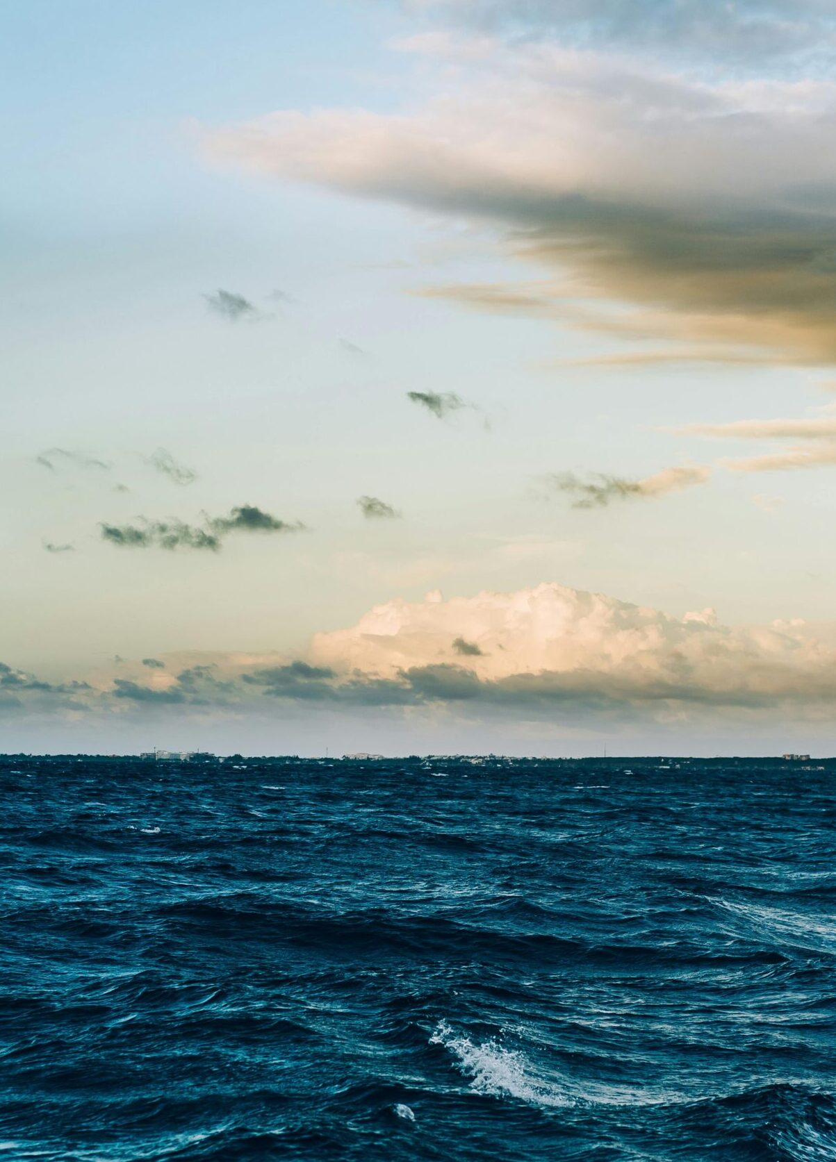 A captivating view of ocean waves under a dramatic twilight sky, offering a peaceful seascape.
